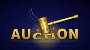 Gold auction gavel striking the word AUCTION